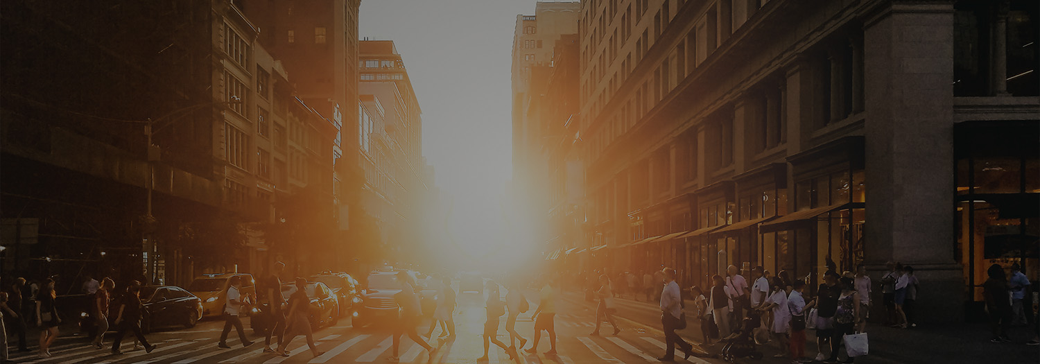 Manhattanhenge sunset over a busy NYC street