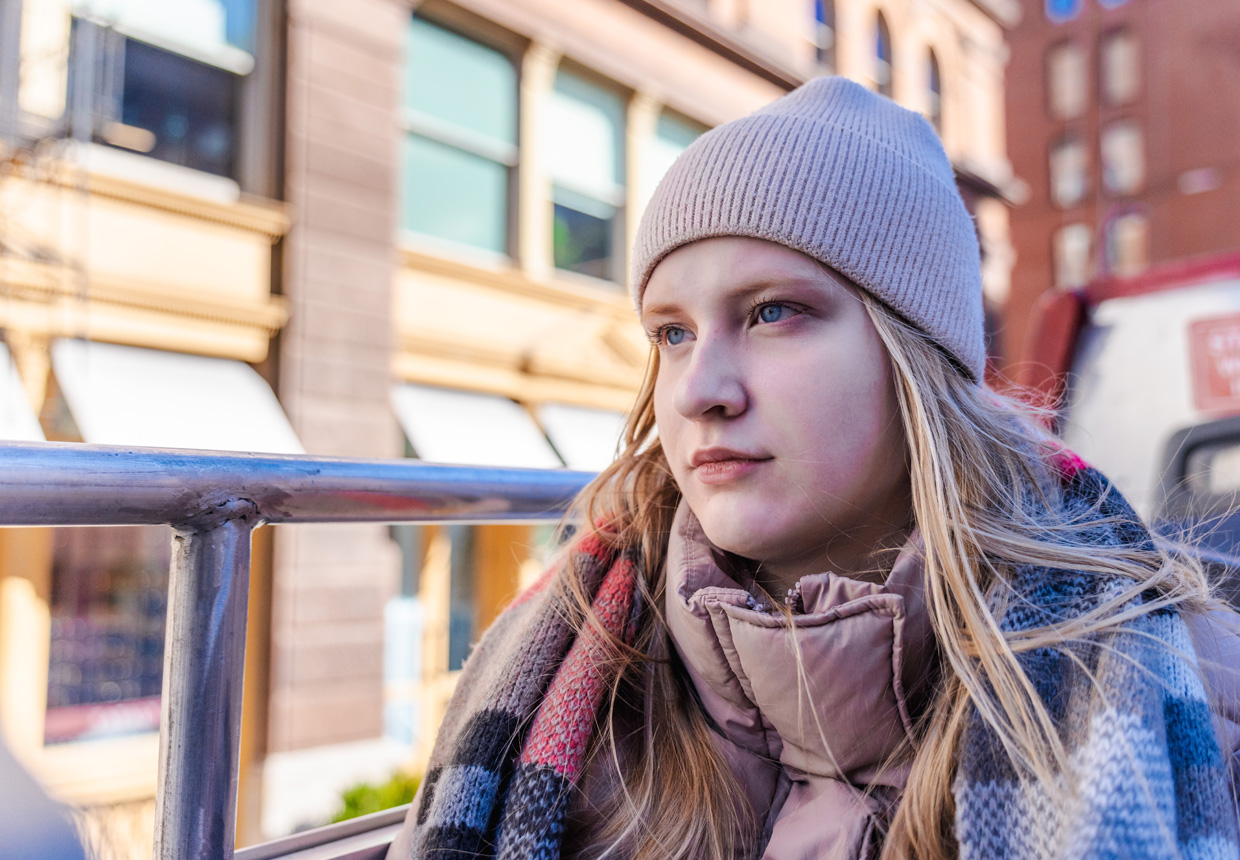 Young woman on a winter city bus tour