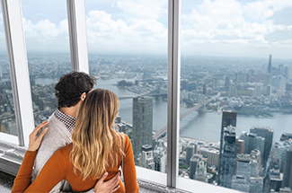 Couple enjoying a panoramic city view from a skyscraper