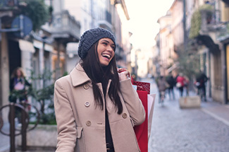 Woman smiling while shopping on a city street