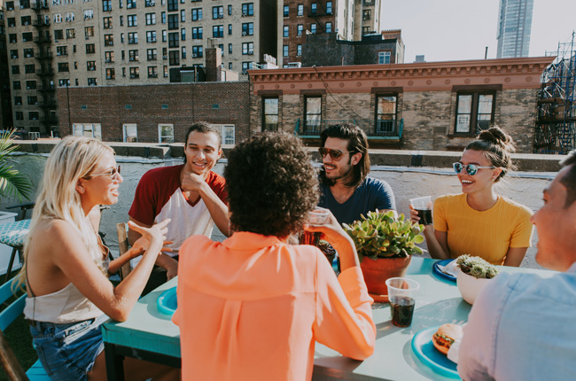 Friends dining on a NYC rooftop terrace